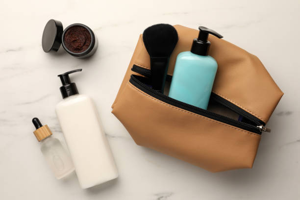 istock Preparation for spa. Compact toiletry bag and different cosmetic products on white table, flat lay 1466751127