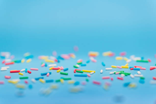 istock colorful sprinkles over blue background, copy space 1466754061