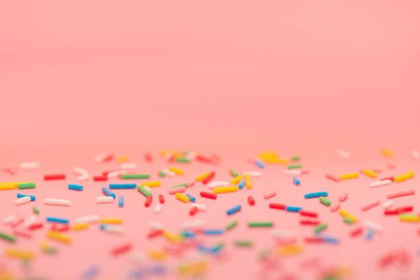 istock colorful sprinkles over pink background, copy space 1466754122