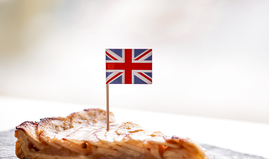 United Kingdom, dessert and bakery, slice of apple tart with British flag, close-up