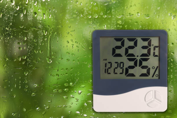 istock Digital hygrometer with thermometer on glass with water drops. Space for text 1466757559