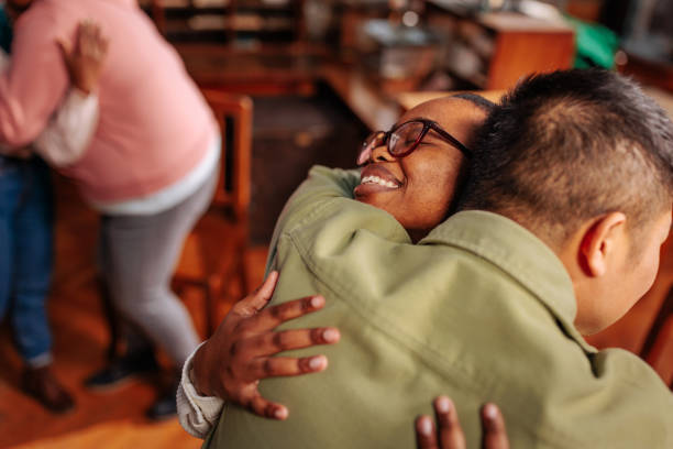 istock Diverse people hugging in group therapy. 1466758153