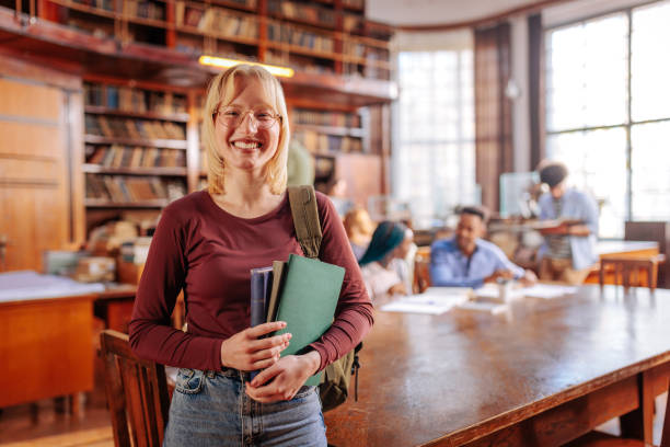 istock Portrait of student in library with copy-space. 1466758170