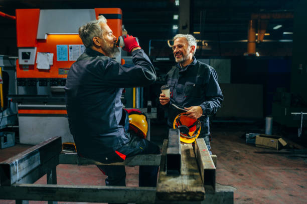 istock Cheerful coworkers drink coffee in workshop. 1466758617