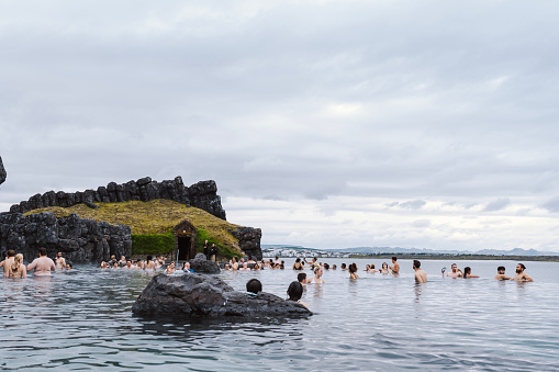 Reykjavik, Iceland - July 17 2022: Sky Lagoon in Iceland. Tourists enjoying geothermal spa with heated water during cold day