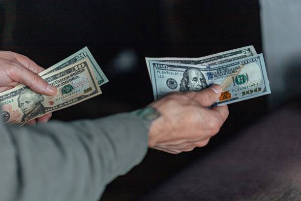 istock Hand with money dollar bills 1466761416