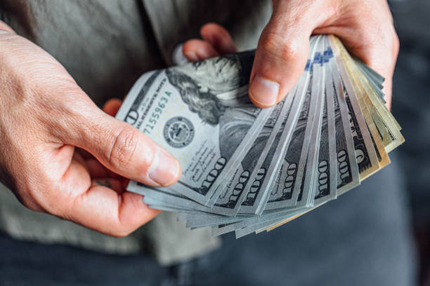 istock Hand with money dollar bills 1466761443