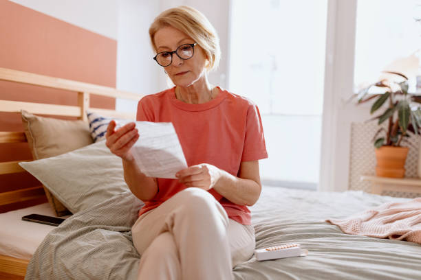 istock Woman reading instructions that came with the Hormone replacement therapy prescription 1466762781