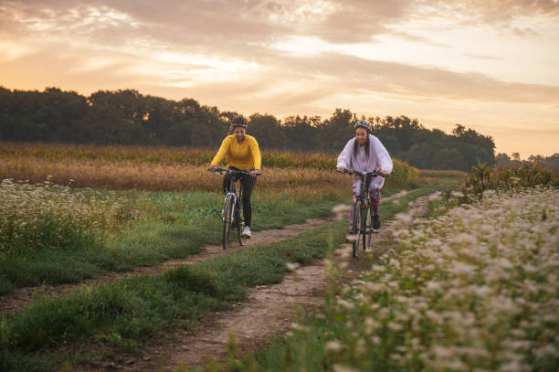 istock Dedicated female athletes practicing cycling on dirt road 1466765732
