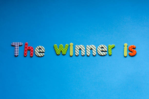 istock colored text  the winner is on blue paper background 1466766665