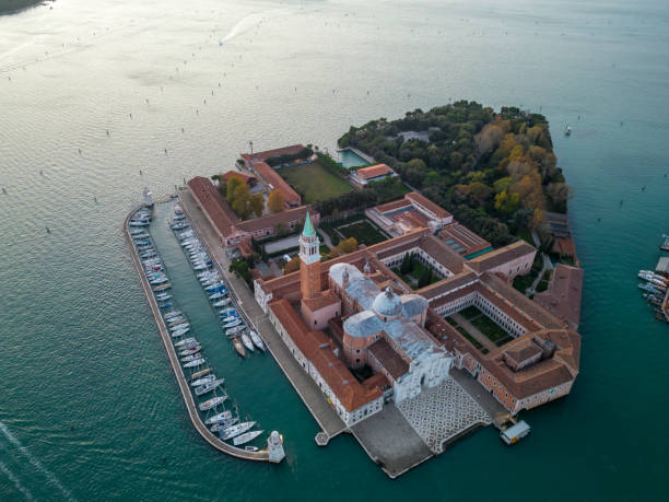 Aerial view of island with Church of San Giorgio Maggiore at Venice Aerial view of boats moored at harbor and island with Church of San Giorgio Maggiore surrounded with seascape at Venice,Italy san giorgio maggiore stock pictures, royalty-free photos & images