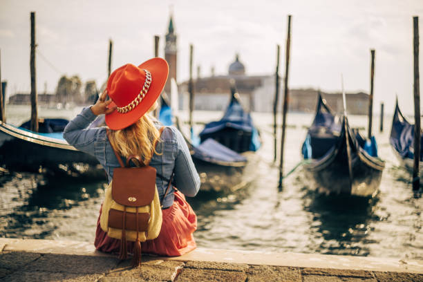 istock Female tourist with backpack wearing hat and exploring Venice 1466766795