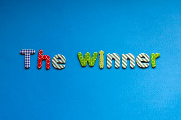 istock colored word  the winner on blue paper background 1466766864