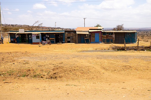 Exterior of old shops on sandy landscape at countryside against cloudy sky on a sunny day at Kenya,East Africa