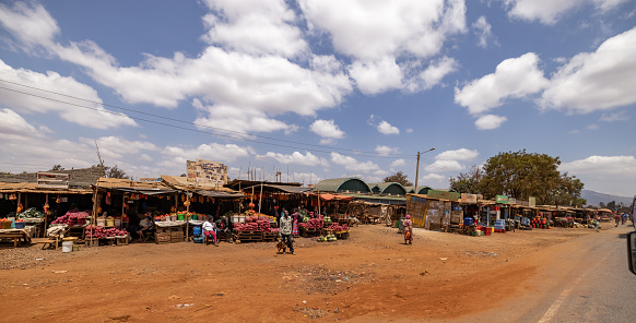 View of market stalls in a row at roadside against cloudy sky on a sunny day at Kenya,East Africa