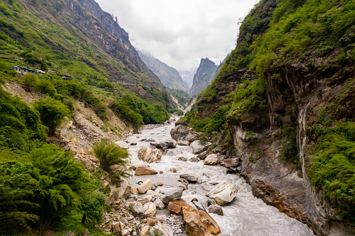 Scenic view of beautiful river flowing amidst majestic against cloudy sky