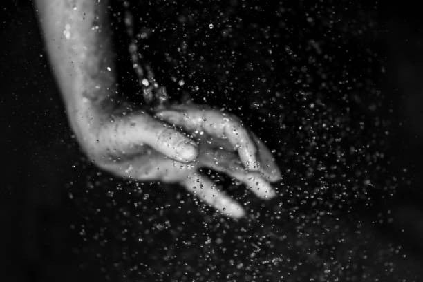 istock human hand in the rain against black background 1466769889