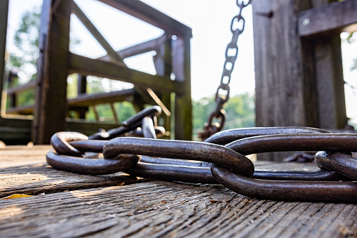 Close-up of old iron chains on wood