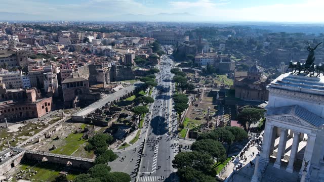 Tourists in Rome. The Colosseum and Via dei Fori Imperiali.