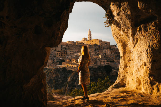 istock Woman looking at cityscape while standing at cave on sunny day 1466771813