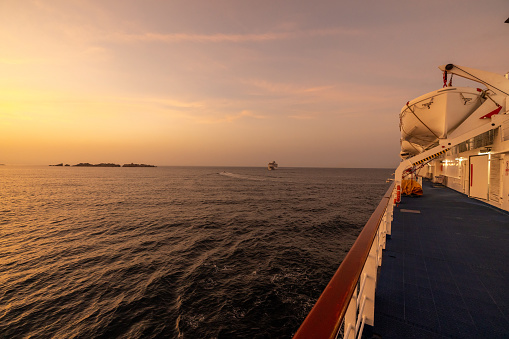 Cruise ship on idyllic seascape against sky during sunset