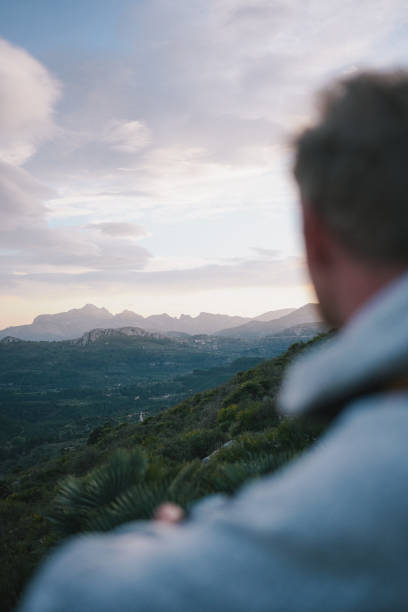 istock Profile of young man watching sunrise over mountains 1466772153