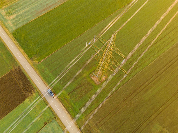 Aerial view of electricity pylons on agricultural field
