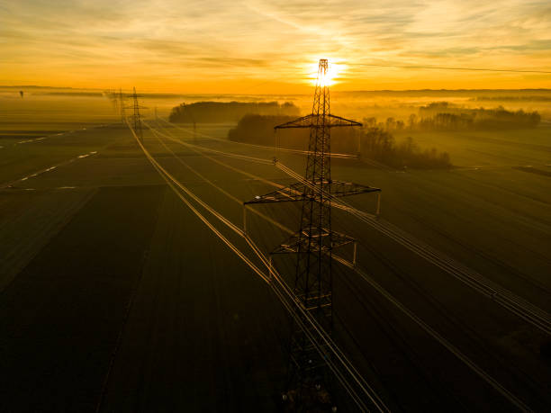 istock Scenic view of electricity pylons on field during sunset 1466772410