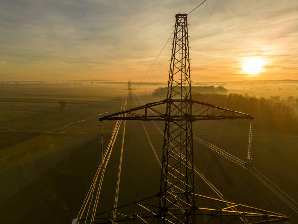 istock Scenic view of electricity pylons on field during sunset 1466772421