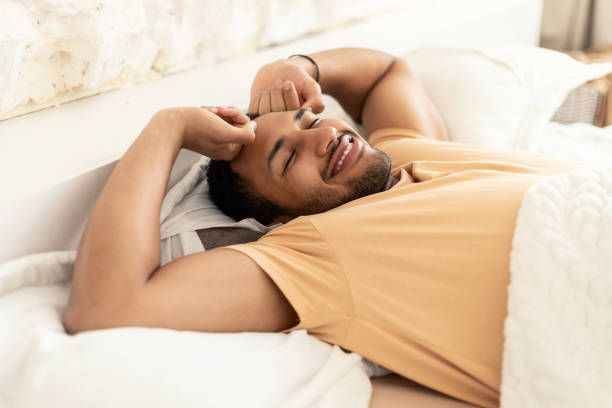 istock Happy Middle Eastern Guy Waking Up In Bed At Home 1466775786