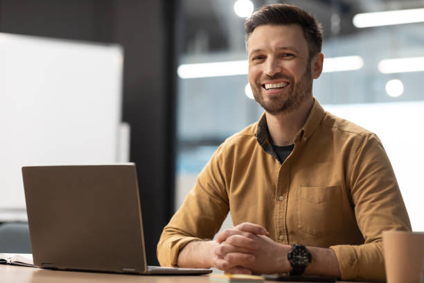 istock Happy Entrepreneur Man Near Laptop Computer Posing In Modern Office 1466775829
