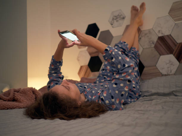 istock Woman in bed typing on her smartphone 1466776489