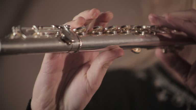 Close up shot of a girl playing the flute