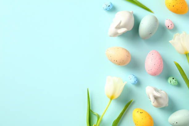 istock Tulips, Easter eggs, bunnies on pastel blue background. Happy Easter greeting card design. 1466777695