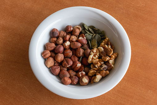 Walnuts, hazelnuts and pumpkin seeds in plate