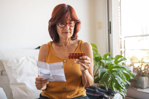istock Latin woman checking patient information leaflet for her medicine. 1466780212
