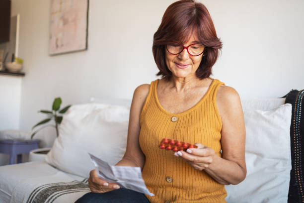istock Latin woman checking patient information leaflet for her medicine. 1466780228