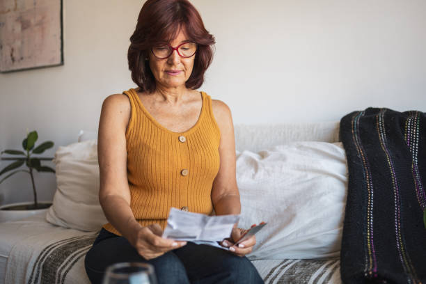 istock Latin woman checking patient information leaflet for her medicine. 1466780229
