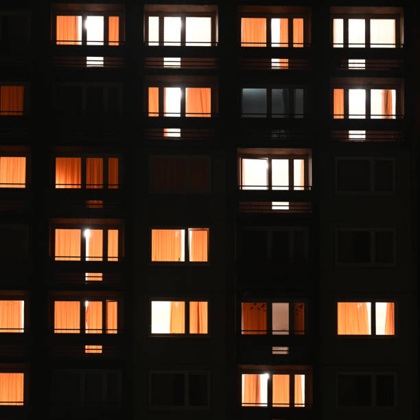 istock Apartment block windows at night square 1466782411