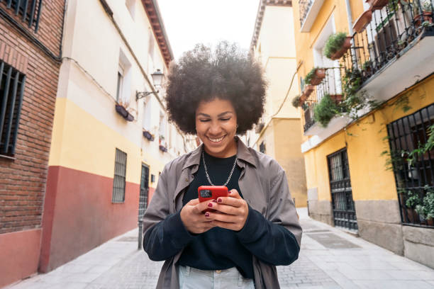 istock Afro Girl Using Phone 1466783418