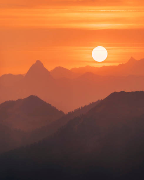 istock Sunrise over snowcapped mountains 1466787478