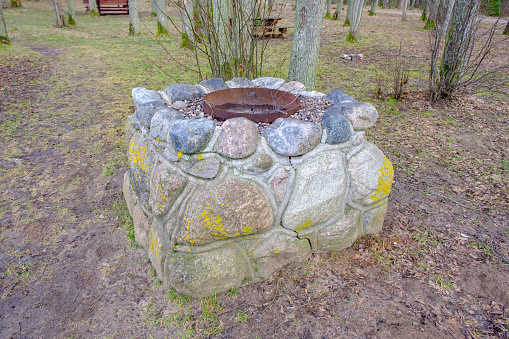 idyllic outdoor barbecue area - built with flat stones campfire place. For public use.
