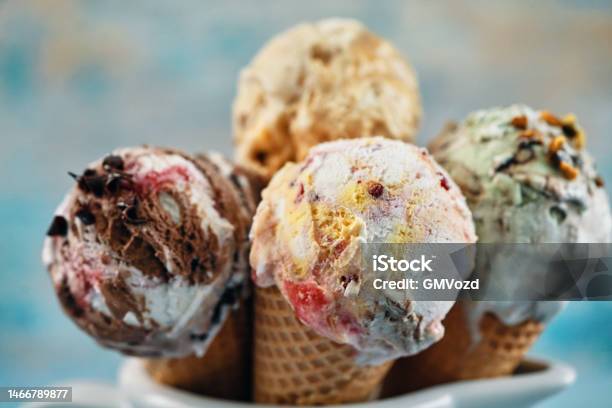 Pistachio Chocolate Strawberry And Vanilla Ice Cream In A Cone Stock Photo - Download Image Now