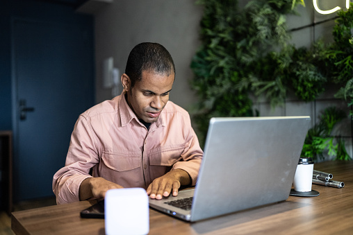 Visually impaired man using the laptop in the office