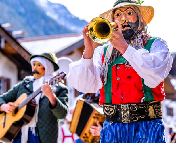 A young man carrying a “Trumpet” musical instrument and another carrying a Silver Chrome Tarol.\nCarnaval de Belo Horizonte
