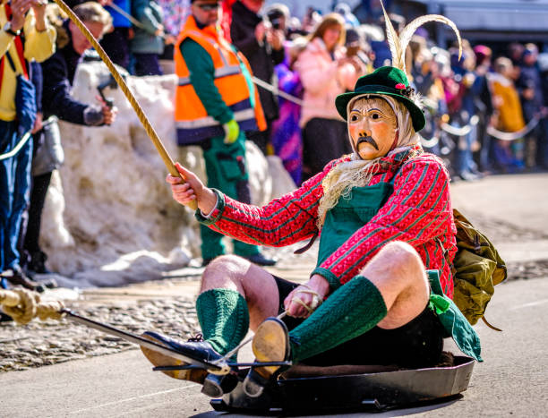 Mittenwald, Germany - February 16: participants of a parade with traditional disguise with large wooden masks and historic costumes called 'maschkera' on February 16, 2023 in Mittenwald