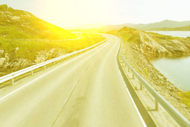 istock road landscape with sun light, Norway 1466797005