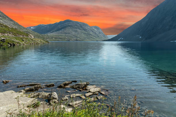 istock Mountain lake landscape with red sunset sky, Norway 1466797007