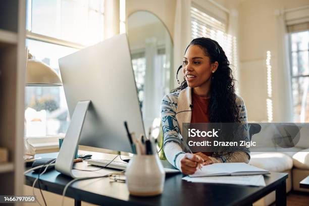 Happy African American Female Student Having Video Call While Elearning At Home Stock Photo - Download Image Now