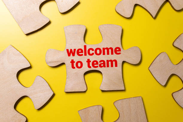 istock welcome to the team is written in a white notebook with calculator, craft colored notepad 1466797584
